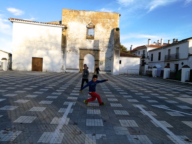 Kids playing football in front of closed-up chapel ruin. Photo © Karethe Linaae